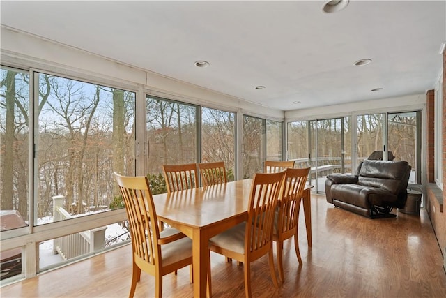 sunroom with a wooded view