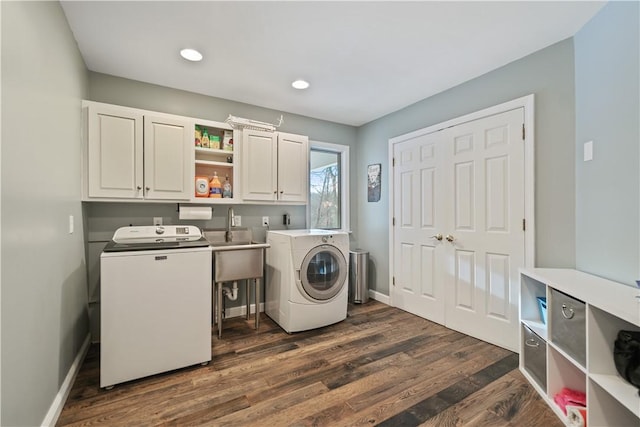 clothes washing area with recessed lighting, cabinet space, dark wood-type flooring, washer and dryer, and baseboards