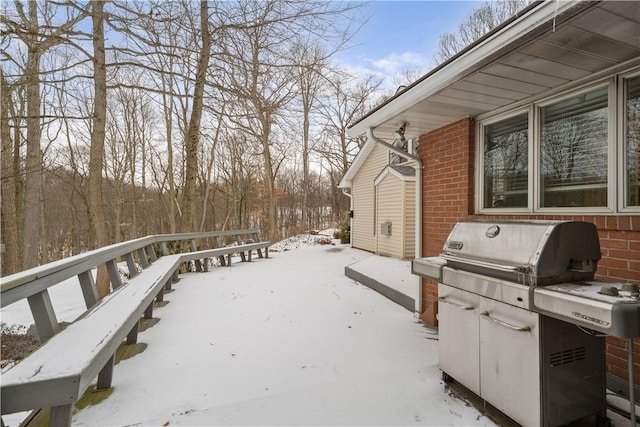 snow covered deck with stairway and grilling area