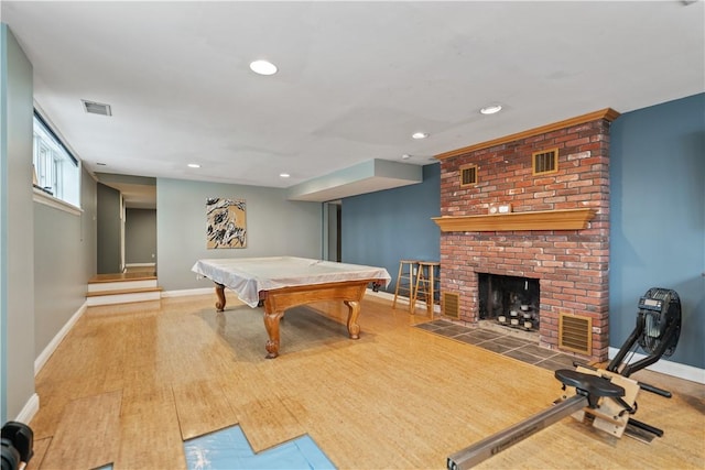 playroom featuring recessed lighting, a fireplace, wood finished floors, visible vents, and baseboards