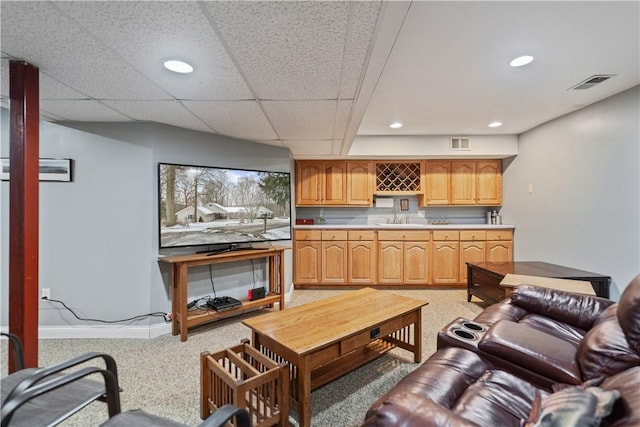 living area with light colored carpet, visible vents, baseboards, and recessed lighting