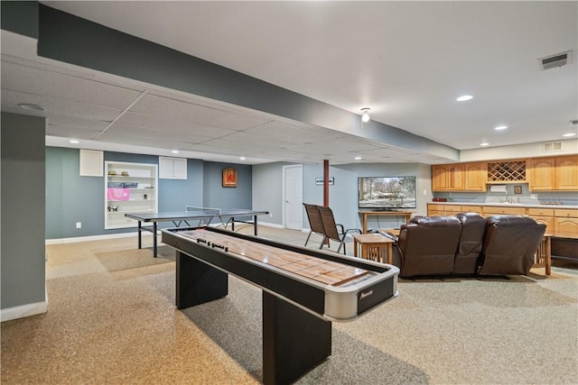 recreation room featuring visible vents, baseboards, a sink, and recessed lighting