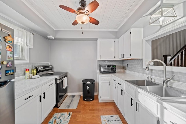 kitchen featuring stainless steel appliances, light wood-type flooring, white cabinets, and a sink