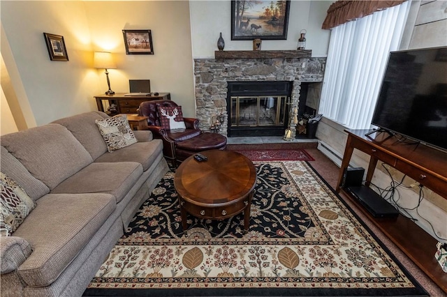 living room with a stone fireplace