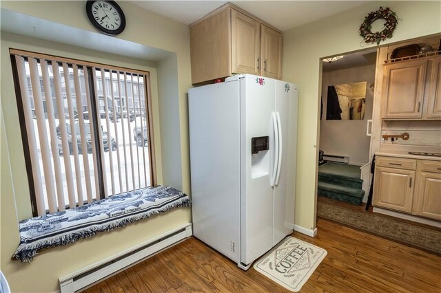 kitchen featuring a baseboard radiator, white refrigerator with ice dispenser, light countertops, and dark wood-style flooring