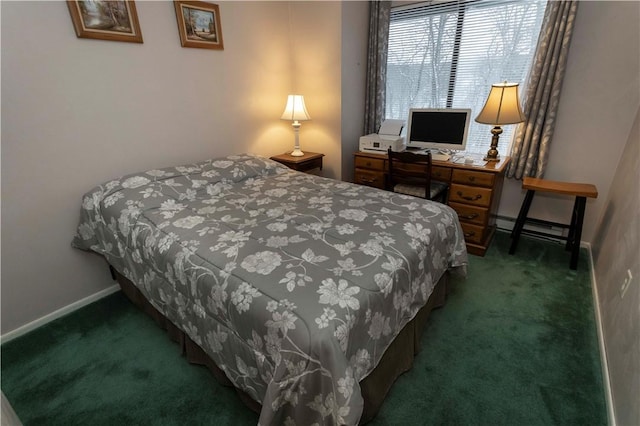 bedroom featuring a baseboard heating unit, dark colored carpet, and baseboards