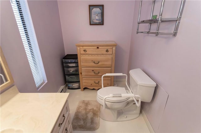 bathroom featuring toilet, a baseboard radiator, vanity, and baseboards