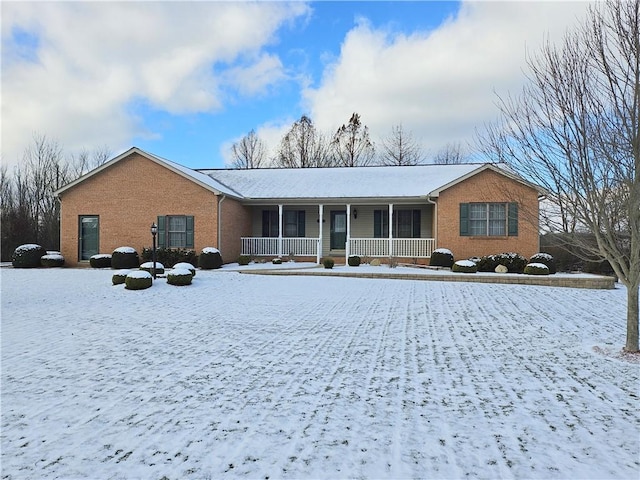 single story home featuring a porch and brick siding