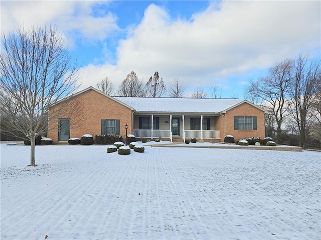 view of front of house with covered porch and brick siding