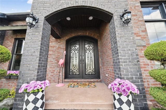 property entrance with brick siding and french doors