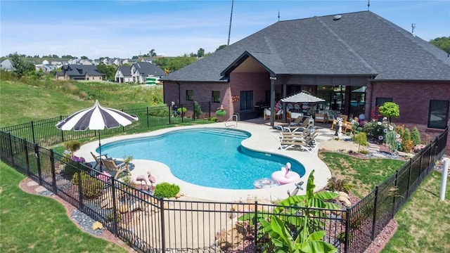 view of pool with a fenced in pool, a yard, fence, a gazebo, and a patio area
