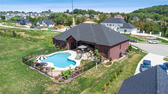 view of pool with a fenced in pool, fence private yard, a patio area, and a residential view