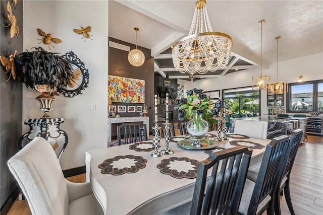 dining space with wood finished floors, beam ceiling, and an inviting chandelier