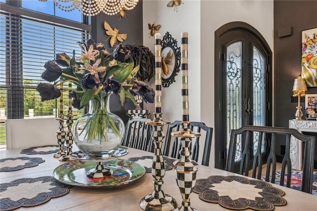 dining space with arched walkways and french doors