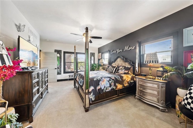 bedroom featuring a ceiling fan and light colored carpet