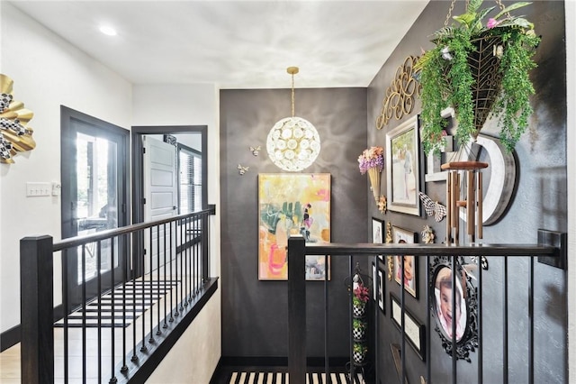 interior space with a notable chandelier and an upstairs landing