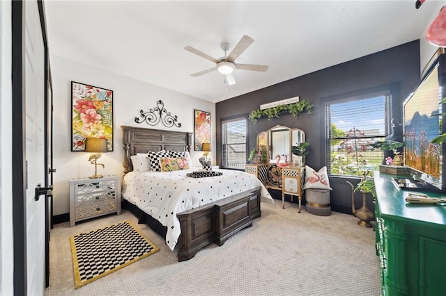 bedroom with light carpet and a ceiling fan