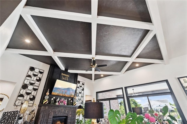 details with ceiling fan, recessed lighting, coffered ceiling, a brick fireplace, and beamed ceiling
