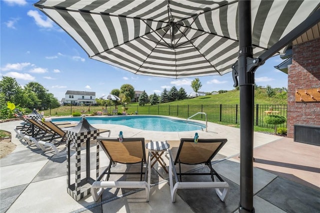 view of swimming pool featuring a patio area, fence, and a fenced in pool