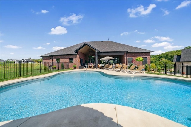 view of swimming pool featuring a patio area, fence, and a fenced in pool
