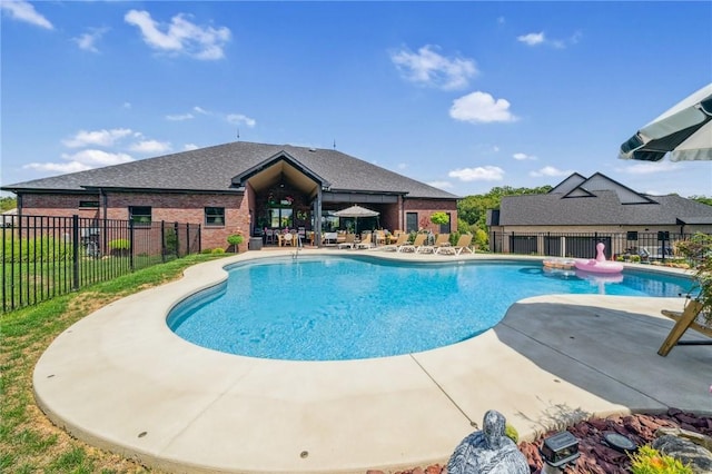 view of swimming pool featuring fence, a fenced in pool, and a patio