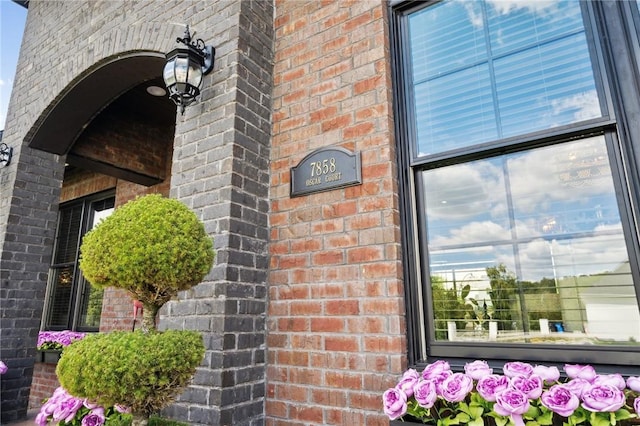 view of exterior entry with brick siding
