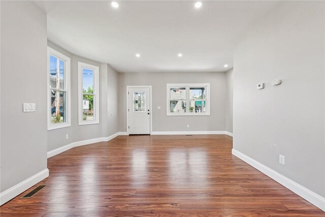 foyer featuring recessed lighting, dark wood finished floors, visible vents, and a healthy amount of sunlight