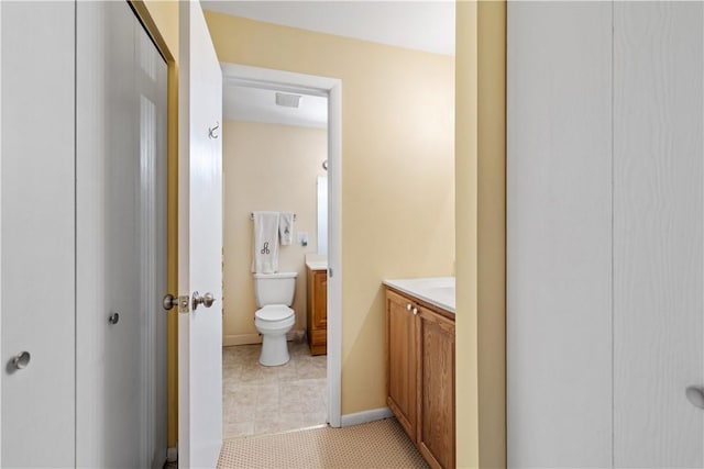 bathroom featuring baseboards, visible vents, toilet, tile patterned floors, and vanity