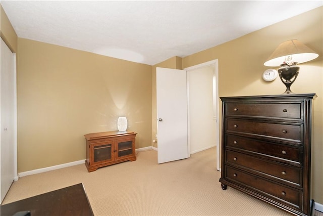 bedroom featuring baseboards and light colored carpet