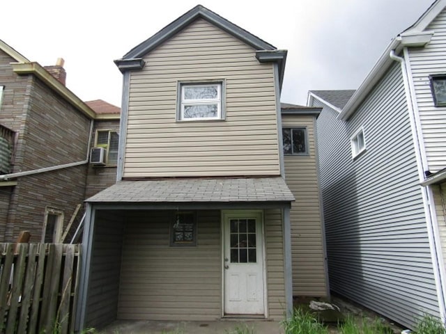rear view of house featuring fence