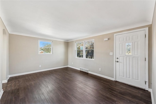 entrance foyer with dark wood-type flooring, visible vents, and baseboards
