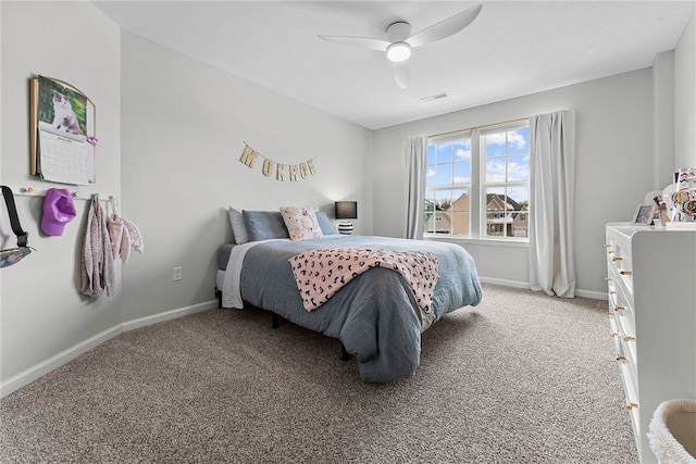 carpeted bedroom with a ceiling fan, visible vents, and baseboards