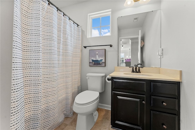 bathroom with toilet, visible vents, a shower with shower curtain, and vanity