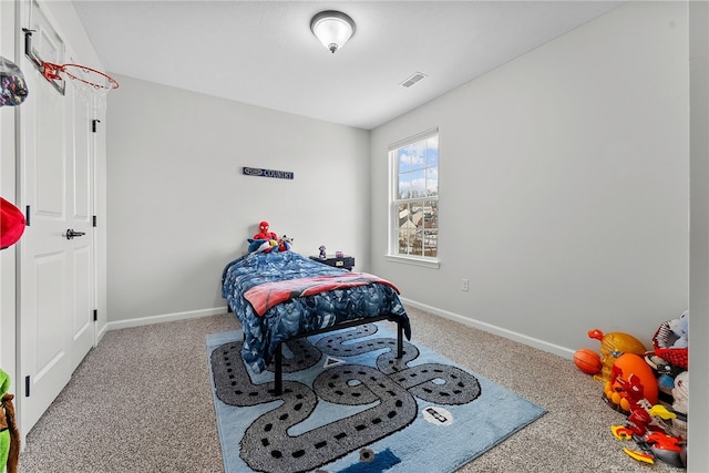 carpeted bedroom with visible vents and baseboards