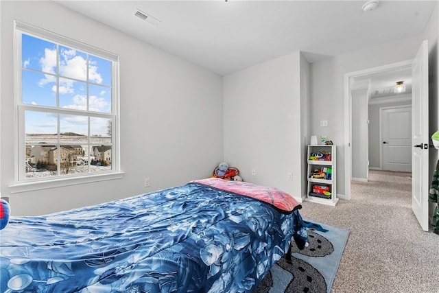 carpeted bedroom featuring baseboards and visible vents