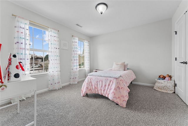 bedroom featuring carpet floors, visible vents, and baseboards