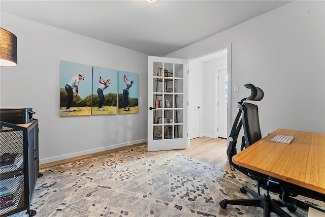 office area featuring light wood-style flooring and baseboards