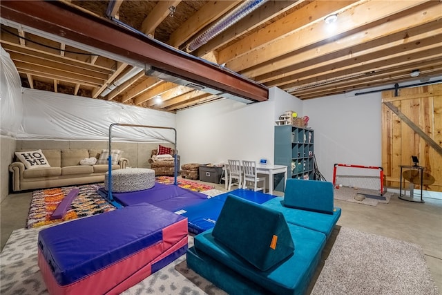 rec room with concrete flooring and a barn door