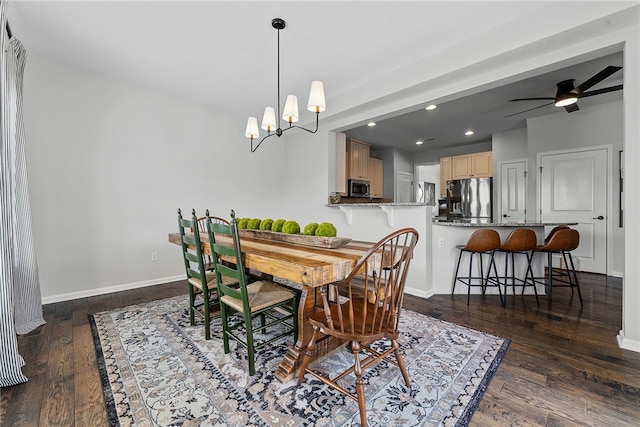 dining space with recessed lighting, baseboards, dark wood finished floors, and ceiling fan with notable chandelier