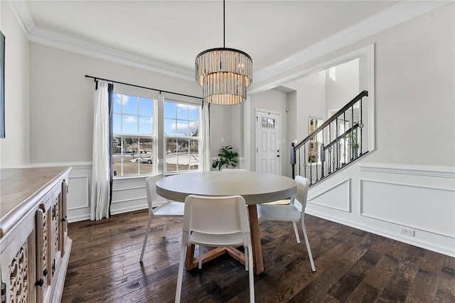 dining area featuring a chandelier, dark wood-style flooring, crown molding, and stairs