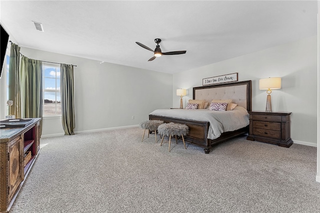 bedroom featuring a ceiling fan, light carpet, visible vents, and baseboards