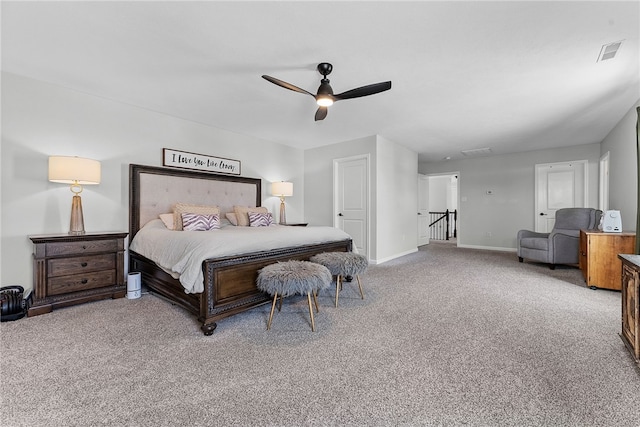 bedroom with light carpet, ceiling fan, visible vents, and baseboards