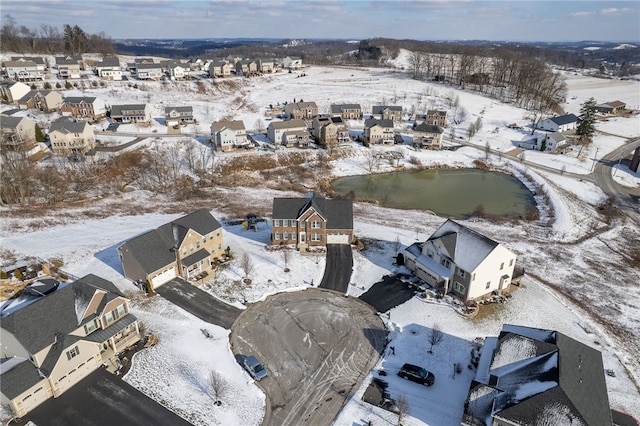 snowy aerial view with a residential view