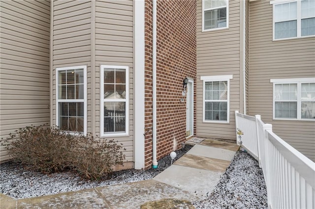 property entrance with brick siding