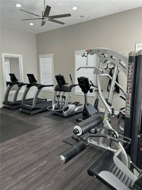 workout area featuring a textured ceiling, ceiling fan, and recessed lighting