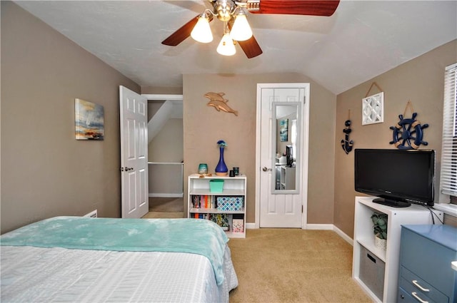 bedroom featuring lofted ceiling, light colored carpet, ceiling fan, and baseboards