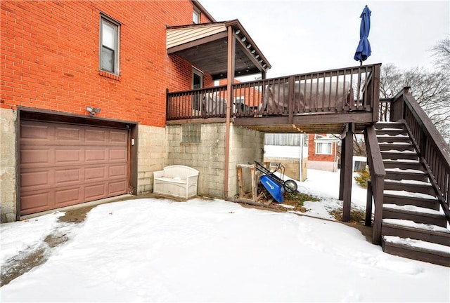 exterior space featuring brick siding, stairway, an attached garage, and a wooden deck