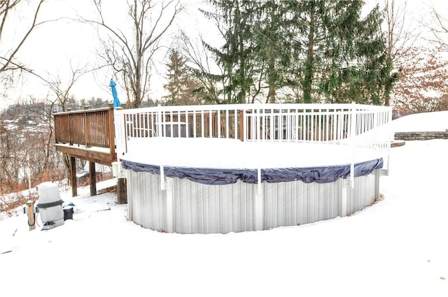 snow covered deck featuring a covered pool