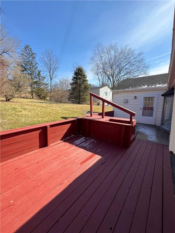 wooden terrace featuring a yard