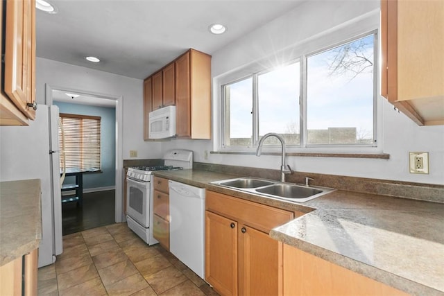 kitchen with white appliances, a sink, and recessed lighting